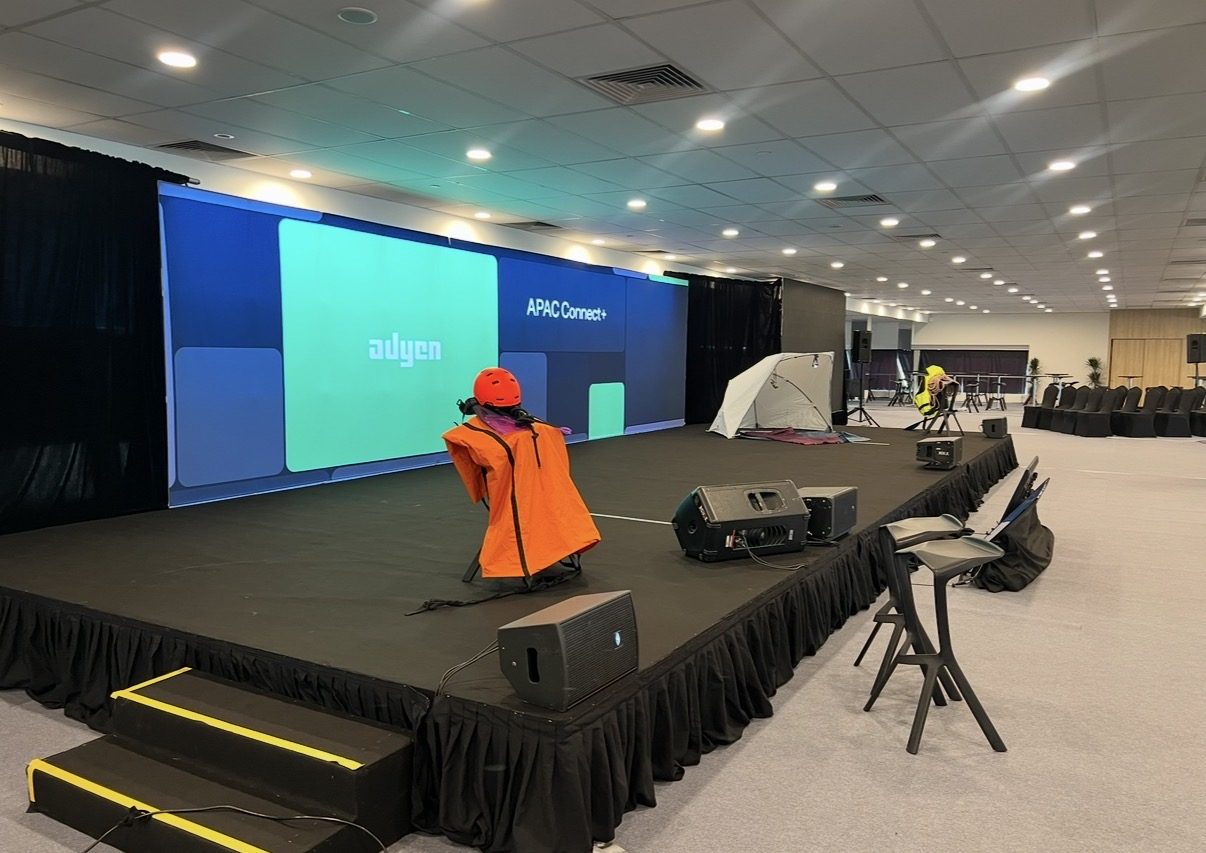 Adyen event stage with backlit screen wall